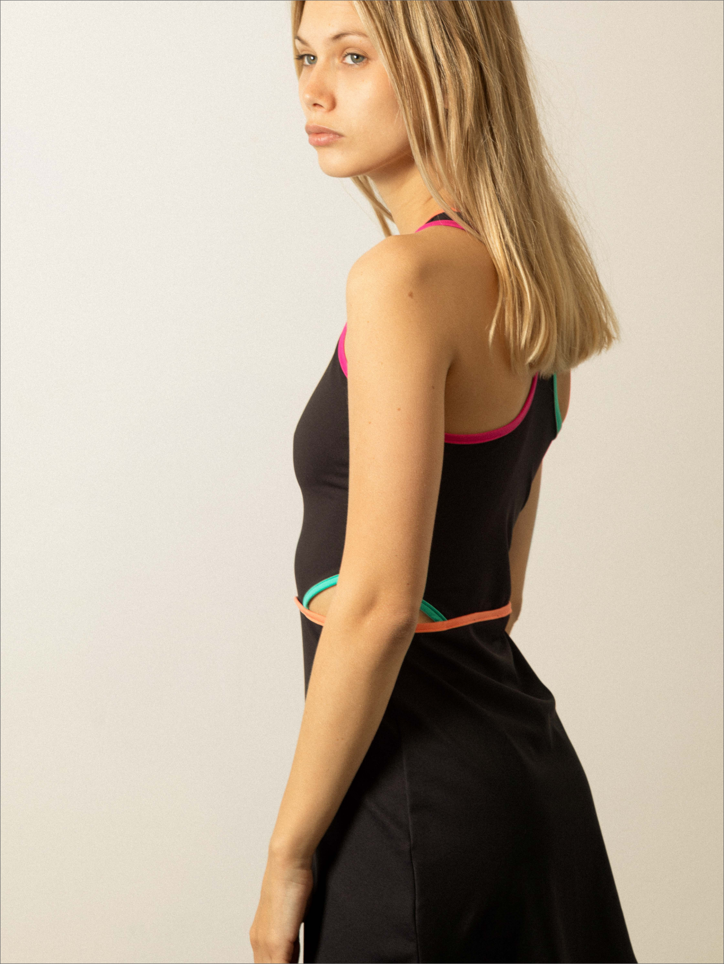 Mujer con vestido negro cut out de padel - lateral